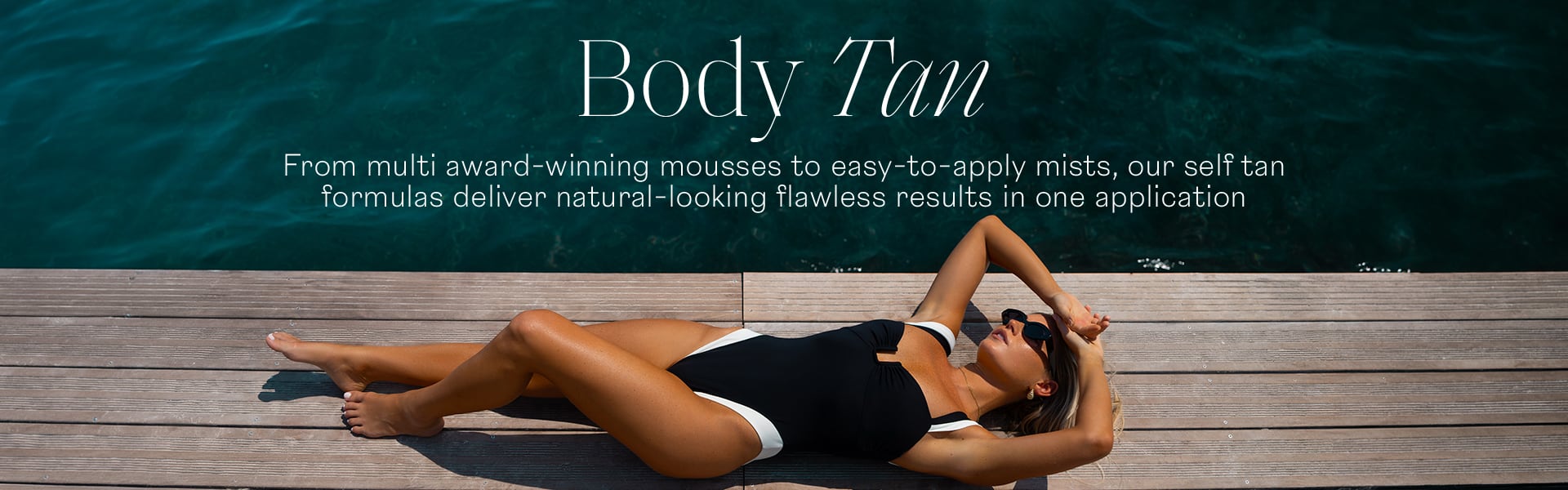 Body Tan woman in bathing suit lying on deck next to sea