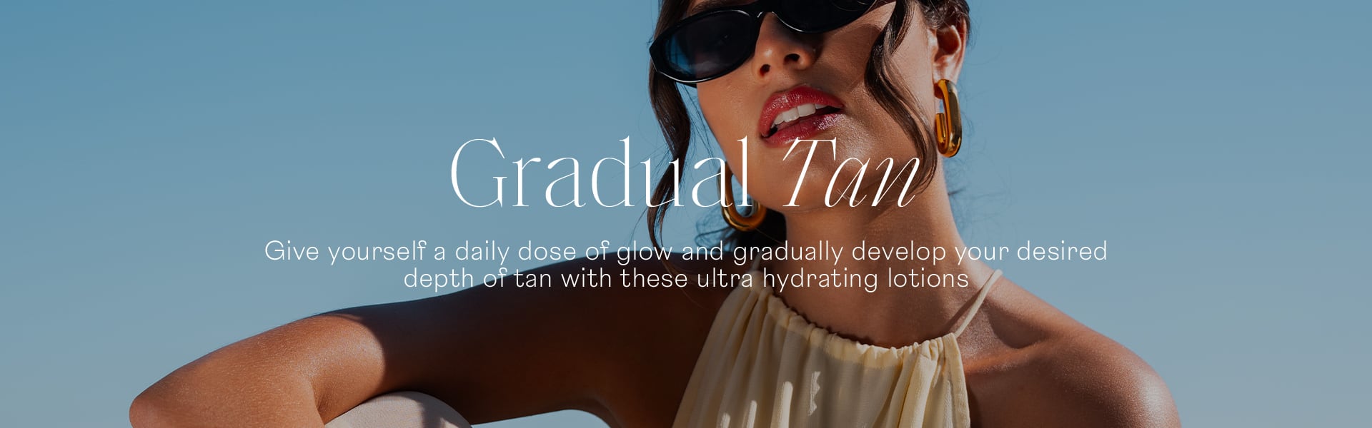 Gradual Tan woman wearing sunglasses sky background